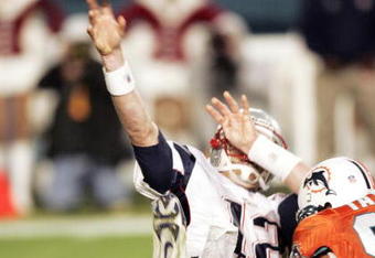 MIAMI - DECEMBER 20: Defensive end Jason Taylor #99 of the Miami Dolphins sacks Quarterback Tom Brady #12 of the New England Patriots at Pro Player Stadium on December 20, 2004 in Miami, Florida. (Photo by Eliot J. Schechter/Getty Images)