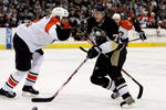 PITTSBURGH - MAY 11:  Evgeni Malkin #71 of the Pittsburgh Penguins is hooked by Derian Hatcher #2 of the Philadelphia Flyers who received a penalty in the third period of game two of the Eastern Conference Finals of the 2008 NHL Stanley Cup Playoffs at Mellon Arena on May 11, 2008 in Pittsburgh, Pennsylvania.  The Penguins won the game 4-2 and lead the series 2-0.  (Photo by Jim McIsaac/Getty Images)