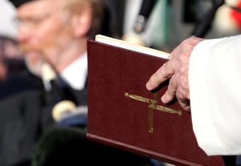MUNICH, GERMANY - FEBRUARY 05:  A priest reads out of bible during the 50th anniversary to commerate the Munich air disaster on February 6, 2008 in Kirchtrudering , Germany. 23 people died in an airplane crash at Munich Airport 50 years ago. Eight Manchester United players were among the dead.  (Photo by Thomas Niedermueller/Getty Images)