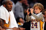 LOS ANGELES, CA - APRIL 9:  KDuke Keaton, 8, son of actress Diane Keaton takes picture of Kobe Bryant #24 of the Los Angeles Lakers during a break in the action against the Denver Nuggets at Staples Center April 9, 2009 in Los Angeles, California.  NOTE TO USER: User expressly acknowledges and agrees that, by downloading and/or using this Photograph, user is consenting to the terms and conditions of the Getty Images License Agreement.  (Photo by Kevork Djansezian/Getty Images)