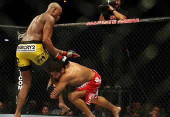 CHICAGO- OCTOBER 25: Anderson Silva (L) wrestles with Patrick Cote  in the Middleweight Title Bout at UFC's Ultimate Fight Night at Allstate Arena on October 25, 2008 in Chicago, Illinois. (Photo by Tasos Katopodis/Getty Images)