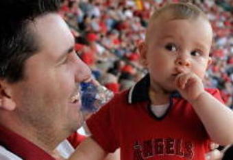 ANAHEIM, CA - APRIL 06:  Ten months old Kayla Duke wearing an Angels cheerleader uniform looks on during Los Angeles Angels of Anaheim opening day game against the Oakland Athletics at the Angels Stadium of Anaheim on April 6, 2009 in Anaheim, California.  (Photo by Kevork Djansezian/Getty Images)