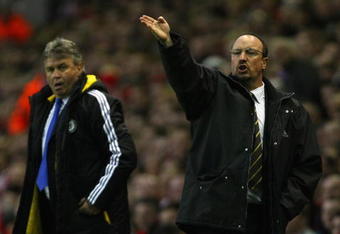 LIVERPOOL, ENGLAND - APRIL 08:  Liverpool Manager Rafael Benitez gestures as Chelsea Caretaker Manager Guus Hiddink looks on during the UEFA Champions League Quarter Final First Leg match between Liverpool and Chelsea at Anfield on April 8, 2009 in Liverpool, England.  (Photo by Clive Rose/Getty Images)