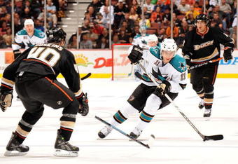 ANAHEIM, CA - OCTOBER 17:  Marcel Goc #11 of the San Jose Sharks skates in with the puck as he is watched by Kent Huskins #40 and Teemu Selanne #8 of the Anaheim Ducks during the second period at the Honda Center on October 17, 2008 in Anaheim, California.  (Photo by Harry How/Getty Images)