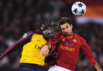ROME - MARCH 11:  Mirko Vucinic of Roma jumps for a header with Bacary Sagna of Arsenal during the UEFA Champions League, Round of Last 16, Second Leg match between AS Roma and Arsenal at the Stadio Olimpico on March 11, 2009 in Rome, Italy.  (Photo by Shaun Botterill/Getty Images)