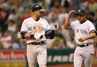 ST. PETERSBURG, FL - JULY 15:  Derek Jeter #2 of the New York Yankees is congratulated by first base coach Tony Pena #52 after Jeter drove in a run with an infield single in the eighth inning against the Tampa Bay Devil Rays on July 15, 2007 at Tropicana Field in St. Petersburg, Florida.  (Photo by Doug Benc/Getty Images)