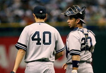 TAMPA, FL - JULY 14:  Starting pitcher Chien-Ming Wang #40 of the New York Yankees talks with catcher Jorge Posada #20 after Wang gave up three runs in the first inning against the Tampa Bay Devil Rays at Tropicana Field on July 14, 2007 in St. Petersburg, Florida.  (Photo by Doug Benc/Getty Images)