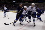 ST. LOUIS - NOVEMBER 23:  David Perron #57 of the St. Louis Blues looks to steal the puck from Brad Isbister #27 and Luc Bourdon #28 both of the Vancouver Canucks at the Scottrade Center November 23, 2007 in St. Louis, Missouri. (Photo by Dilip Vishwanat/Getty Images)