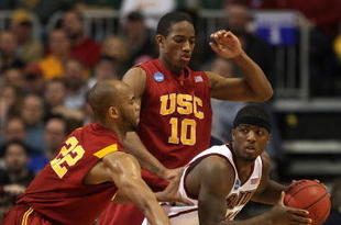 MINNEAPOLIS - MARCH 20:  Corey Raji #11 of the Boston College Eagles looks to pass the ball as he is double teamed by Taj Gibson #22 and DeMar DeRozan #10 of the USC Trojans during the first round of the NCAA Division I Men's Basketball Tournament at the Hubert H. Humphrey Metrodome on March 20, 2009 in Minneapolis, Minnesota.  (Photo by Jonathan Daniel/Getty Images)