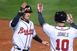 ATLANTA - APRIL 10:  Outfielder Jordan Schafer #24 (left) of the Atlanta Braves scores the winning run in extra innings against the Washington Nationals April 10, 2009 in Atlanta, Georgia.  The Braves won 6 - 5. (Photo by Al Messerschmidt/Getty Images)