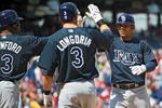 PHILADELPHIA - APRIL 4: First baseman Carlos Pena #23 of the Tampa Bay Rays gets congratulated by teammates left fielder Carl Crawford #13 and third baseman Evan Longoria #3 after hitting a 3 run home-run in the top of the first inning during the game against the Philadelphia Phillies on April 4, 2009 at Citizens Bank Park in Philadelphia, Pennsylvania.  The Rays won 9-7. (Photo by Drew Hallowell/Getty Images)