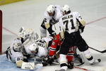 CHICAGO - FEBRUARY 27: Rusian Fedotenko #26 of the Pittsburgh Penguins slides into goaltender Marc-Andre-Fleury #29 after Fleury saved a shot by Andrew Ladd #16 of the Chicago Blackhawks as Hall Gill #2 and Evgeni Malkin #71 defend on February 27, 2009 at the United Center in Chicago, Illinois. (Photo by Jonathan Daniel/Getty Images)