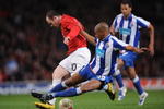 MANCHESTER, ENGLAND - APRIL 07:  Wayne Rooney of Manchester United is tackled by Fernando of FC Porto during the UEFA Champions League Quarter Final First Leg match between Manchester United and FC Porto at Old Trafford on April 7, 2009 in Manchester, England.  (Photo by Shaun Botterill/Getty Images)