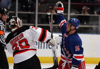 NEW YORK - APRIL 13: Sean Avery #16 of the New York Rangers tries to screen Martin Brodeur #30 of the New Jersey Devils during game three of the 2008 NHL Eastern Conference Quarterfinals on April 13, 2008 at Madison Square Garden in New York City.  (Photo by Jim McIsaac/Getty Images)
