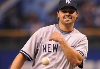ST. PETERSBURG, FL - APRIL 13: Infielder Nick Swisher #33 of the New York Yankees throws out a ball after claiming a strikeout as a pitcher against the Tampa Bay Rays April 13, 2009 in St. Petersburg, Florida.  (Photo by Al Messerschmidt/Getty Images)