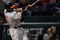 ARLINGTON, TX - APRIL 13:  Adam Jones #10 of the Baltimore Orioles hits a RBI double against the Texas Rangers in the fourth inning on April 13, 2009 at Rangers Ballpark in Arlington, Texas.  (Photo by Ronald Martinez/Getty Images)