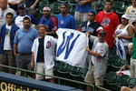 MILWAUKEE - JULY 31:  Fans of the Chicago Cubs hold up a win flag along the first baseline after the Cubs complete a four game sweep of the Milwaukee Brewers at Miller Park on July 31, 2008 in Milwaukee, Wisconsin. The Cubs defeated the Brewers 11-4.  (Photo by Jonathan Daniel/Getty Images)