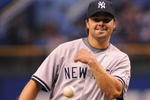 ST. PETERSBURG, FL - APRIL 13: Infielder Nick Swisher #33 of the New York Yankees throws out a ball after claiming a strikeout as a pitcher against the Tampa Bay Rays April 13, 2009 in St. Petersburg, Florida.  (Photo by Al Messerschmidt/Getty Images)