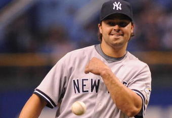 ST. PETERSBURG, FL - APRIL 13: Infielder Nick Swisher #33 of the New York Yankees throws out a ball after claiming a strikeout as a pitcher against the Tampa Bay Rays April 13, 2009 in St. Petersburg, Florida.  (Photo by Al Messerschmidt/Getty Images)