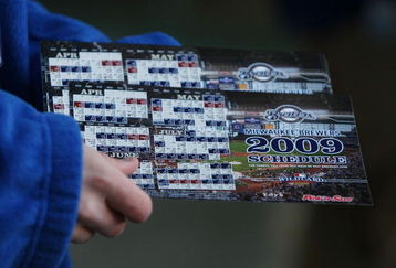 MILWAUKEE - APRIL 10: An usher prepares to hand out Milwaukee Brewers magnet schedules to fans arriving for the Opening Day game against the Chicago Cubs on April 10, 2009 at Miller Park in Milwaukee, Wisconsin. (Photo byJonathan Daniel/Getty Images)