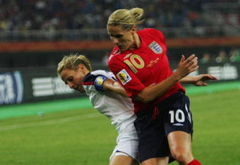 TIANJIN, CHINA - SEPTEMBER 22: Kristine Lilly (L) of USA battles a ball with Kelly Smith of England during the Womens World Cup 2007 Quarter Final match between the USA and England at Tianjin Olympic Center Stadium September 22, 2007 in Tianjin, China.  (Photo by Guang Niu/Getty Images)