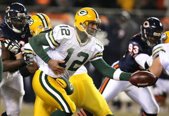 CHICAGO - DECEMBER 22: Aaron Rodgers #12 of the Green Bay Packers turns to hand off against the Chicago Bears on December 22, 2008 at Soldier Field in Chicago, Illinois. The Bears defeated the Packers 20-17 in overtime. (Photo by Jonathan Daniel/Getty Images)