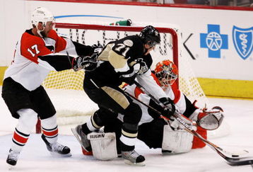 PITTSBURGH - MAY 18:  Evgeni Malkin #71 of the Pittsburgh Penguins charges goaltender Martin Biron #43 of the Philadelphia Flyers in front of Jeff Carter #17 during game five of the Eastern Conference Finals of the 2008 NHL Stanley Cup Playoffs at Mellon Arena on May 18, 2008 in Pittsburgh, Pennsylvania.  The Penguins won the game 6-0 and win the series 4-1 to advance to the Stanley Cup Finals.  (Photo by Jim McIsaac/Getty Images)