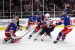 NEW YORK - FEBRUARY 11:  Tomas Fleischmann #14  of the Washington Capitals has his shot deflected by Henrik Lundqvist #30 of the New York Rangers on February 11, 2009 at Madison Square Garden in New York City, New York.  (Photo by Nick Laham/Getty Images)