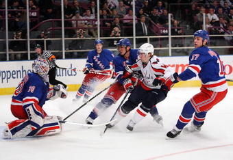 NEW YORK - FEBRUARY 11:  Tomas Fleischmann #14  of the Washington Capitals has his shot deflected by Henrik Lundqvist #30 of the New York Rangers on February 11, 2009 at Madison Square Garden in New York City, New York.  (Photo by Nick Laham/Getty Images)