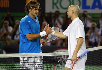 MELBOURNE, AUSTRALIA - JANUARY 25:  Andre Agassi of the USA congratulates Roger Federer of Switzerland after winning their match during day nine of the Australian Open Grand Slam at Melbourne Park January 25, 2005 in Melbourne, Australia. (Photo by Cameron Spencer/Getty Images)