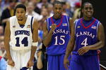 SAN ANTONIO - APRIL 07:  Mario Chalmers #15 of the Kansas Jayhawks reacts in overtime along with teammate Sherron Collins #4 as Chris Douglas-Roberts #14 of the Memphis Tigers looks on during the 2008 NCAA Men's National Championship game at the Alamodome on April 7, 2008 in San Antonio, Texas. The Jayhawks defeated the Tigers 75-68.  (Photo by Ronald Martinez/Getty Images)