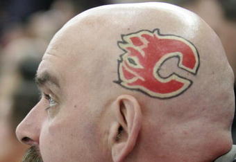 EDMONTON, AB - MARCH 3: A Calgary Flames fan sports the Flames logo on the side of his shaved head while watching the Flames take on the Edmonton Oilers in first period at Rexall Place on March 3, 2007, in Edmonton, Alberta, Canada. (Photo by Tim Smith/Getty Images)