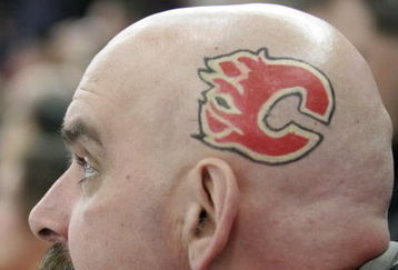 EDMONTON, AB - MARCH 3: A Calgary Flames fan sports the Flames logo on the side of his shaved head while watching the Flames take on the Edmonton Oilers in first period at Rexall Place on March 3, 2007, in Edmonton, Alberta, Canada. (Photo by Tim Smith/Getty Images)