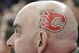 EDMONTON, AB - MARCH 3: A Calgary Flames fan sports the Flames logo on the side of his shaved head while watching the Flames take on the Edmonton Oilers in first period at Rexall Place on March 3, 2007, in Edmonton, Alberta, Canada. (Photo by Tim Smith/Getty Images)