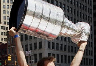 DETROIT - JUNE 06:  Nicklas Lidstrom #5 of the Detroit Red Wings holds up the Stanley Cup during a parade to celebrate winning the 2008 Stanley Cup on June 6, 2008 in Detroit, Michigan.  (Photo by Gregory Shamus/Getty Images)