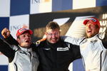 MELBOURNE, AUSTRALIA - MARCH 29:  Race winner Jenson Button (R) of Great Britain and Brawn GP celebrates with Team Principal Ross Brawn (C) and second placed Rubens Barrichello (L) of Brazil and Brawn GP on the podium after the Australian Formula One Grand Prix at the Albert Park Circuit on March 29, 2009 in Melbourne, Australia.  (Photo by Clive Mason/Getty Images)