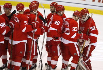 DETROIT - APRIL 26: Chris Osgood #30 of the Detroit Red Wings is congratulated by Kris Draper #33 after a 5-1 victory over the Colorado Avalanche in game two of the Western Conference Quarterfinals of the 2008 NHL Stanley Cup Playoffs on April 26, 2008 at Joe Louis Arena in Detroit, Michigan.  (Photo by Gregory Shamus/Getty Images)  