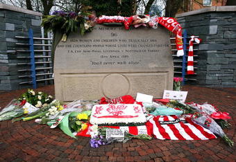 SHEFFIELD, ENGLAND - APRIL 14:  Floral tributes and Liverpool scarves lay in tribute on the Hillsborough disaster memorial at Sheffield Wednesday FC on the eve of the 20th anniversary of the Hillsborough disaster on April 14, 2009, Sheffield, England. Sheffield Wednesday FC are not holding an official service to mark the disaster but will be opening the Leppings lane end for people wishing to pay their respects. A total of 96 Liverpool supporters lost their lives during a crush at an FA Cup semi final against Nottingham Forest at the Hillsborough football ground in Sheffield, South Yorkshire on April 15, 1989.  (Photo by Christopher Furlong/Getty Images)