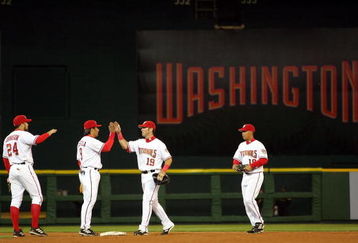 WASHINGTON - APRIL 14: (L-R) Nick Johnson #24 Vinny Castilla #9, Ryan Church #19 and Terrmel Sledge #19 of the Washington Nationals celebrate after beating the Arizona Diamondbacks 5-3 during the Nationals home opener April 14, 2005 at RFK Stadium in Washington, DC. (Photo by Jamie Squire/Getty Images)