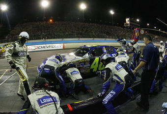 PHOENIX - APRIL 22:  Jimmie Johnson, driver of the #48 Lowe's Chevrolet car, has his car worked on in the pit by his crew during the NASCAR Nextel Cup Series SUBWAY Fresh 500 on April 22, 2006 at the Phoenix International Speedway in Phoenix, Arizona.  (Photo by Rusty Jarrett/Getty Images for NASCAR)