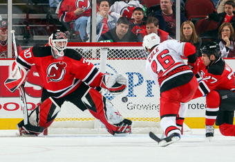 NEWARK, NJ - APRIL 11:  Erik Cole #26 of the Carolina Hurricanes is stopped by Martin Brodeur #30 of the New Jersey Devils at the Prudential Center on April 11, 2009 in Newark, New Jersey.  (Photo by Jim McIsaac/Getty Images)
