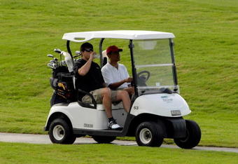 KAILUA, HI - DECEMBER 29:  (AFP OUT) U.S. President-elect Barack Obama (C) drives his golf cart with his Punahou School classmate Greg Orme (L) as they play golf with friends December 29, 2008 in Kailua, Hawaii. Obama and his family have been in his native Hawaii since December 20 for the Christmas holiday.  (Photo by Joaquin Siopack-Pool/Getty Images)