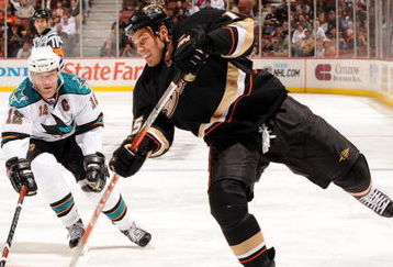 ANAHEIM, CA - OCTOBER 17:  Ryan Getzlaf #15 of the Anaheim Ducks shoots the puck in front of Patrick Marleau #12 of the San Jose Sharks during the third period at the Honda Center on October 17, 2008 in Anaheim, California.  (Photo by Harry How/Getty Images)
