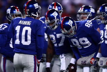 EAST RUTHERFORD, NJ - DECEMBER 21:  Quarterback Eli Manning #10 of the New York Giants talks to his team in a huddle before a play against the Carolina Panthers on December 21, 2008 at Giants Stadium in East Rutherford, New Jersey.  (Photo by Chris McGrath/Getty Images)