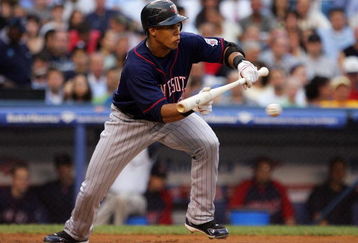 NEW YORK - JULY 22:  Carlos Gomez #22 of the Minnesota Twins attempts a bunt against the New York Yankees at Yankee Stadium July 22, 2008 in the Bronx borough of New York City.  (Photo by Jim McIsaac/Getty Images)