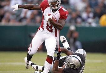 OAKLAND, CA - AUGUST 11:  Wide receiver Anquan Boldin #81 of the Arizona Cardinals drags an Oakland Raiders defender on August 11, 2007 at McAfee Stadium in Oakland, California.  (Photo by Greg Trott/Getty Images)