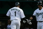 MIAMI - APRIL 06:  Emilio Bonifacio #1 of the Florida Marlins is congratulated by Jorge Cantu #3 after scoring in the thrid inning against the Washington Nationals on opening day at Dolphin Stadium on April 6, 2009 in Miami, Florida.  (Photo by Doug Benc/Getty Images)