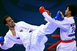 DOHA, QATAR - DECEMBER 13:  Kushal Shresta (R) of Nepal receives a kick to the face from Fadi Al Najjar (L) of Jordan during the Men's Karate 65kg preliminary round match during the 15th Asian Games Doha 2006 at The Qatar Sports Club Indoor Hall, Dedcember13, 2006 in Doha, Qatar.  (Photo by Jamie Squire/Getty Images)