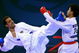 DOHA, QATAR - DECEMBER 13:  Kushal Shresta (R) of Nepal receives a kick to the face from Fadi Al Najjar (L) of Jordan during the Men's Karate 65kg preliminary round match during the 15th Asian Games Doha 2006 at The Qatar Sports Club Indoor Hall, Dedcember13, 2006 in Doha, Qatar.  (Photo by Jamie Squire/Getty Images)