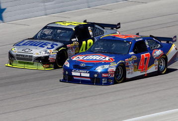 FORT WORTH, TX - APRIL 05:  Jimmie Johnson, driver of the #48 Kobalt Tools Chevrolet, races Marcos Ambrose, driver of the #47 Clorox Toyota, during the NASCAR Sprint Cup Series Samsung 500 at Texas Motor Speedway on April 5, 2009 in Fort Worth, Texas.  (Photo by John Harrelson/Getty Images)